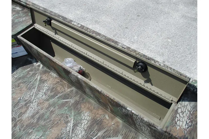 Slide: The Image of Open storage compartment on 2026 G3 Gator Tough 16 DK boat, featuring camouflage design. - 11