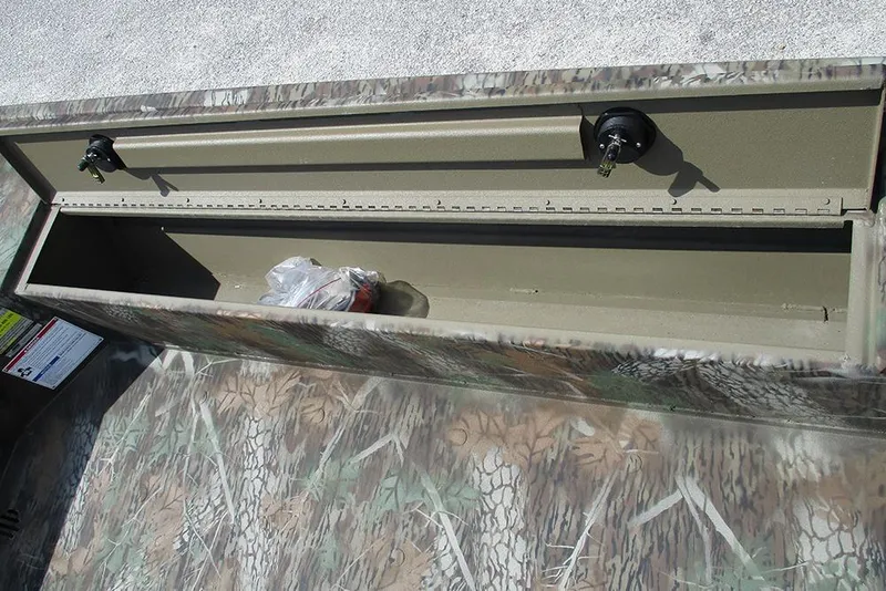 Slide: The Image of Open storage compartment of 2026 G3 Gator Tough 16 DK boat with camouflage design. - 12