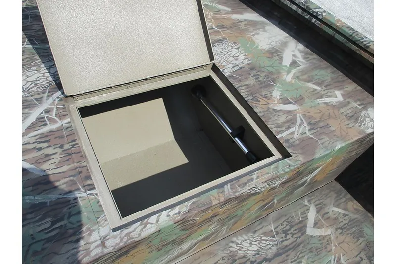 Slide: The Image of Open storage compartment on 2026 G3 Gator Tough 16 DK boat with camouflage design. - 15