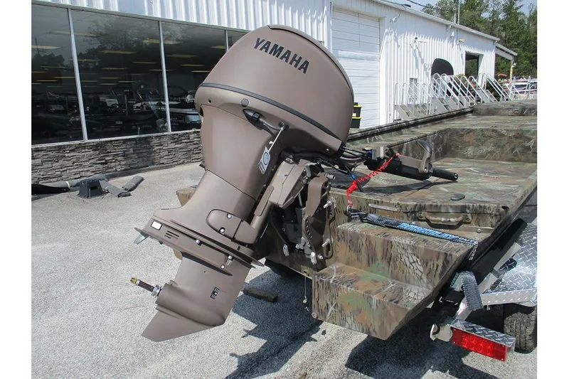 Slide: The Image of 2026 G3 Gator Tough 16 DK boat with Yamaha outboard motor, camo design, parked outdoors. - 8