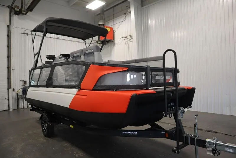 The Image of 2024 Sea-Doo Switch Cruise 21 pontoon boat in a warehouse setting. - 1