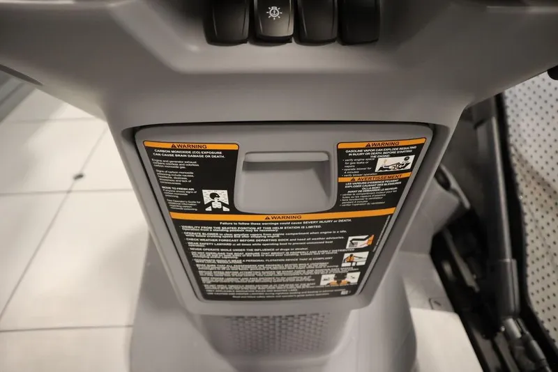 Slide: The Image of 2024 Sea-Doo Switch Cruise 21 dashboard with safety warnings and controls. - 23