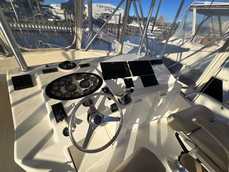 Slide: The Image of Cockpit of 2001 Ocean Yachts 43 Super Sport with steering wheel and control panels. - 22