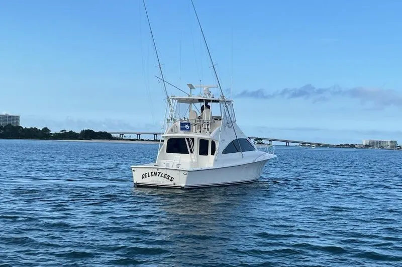Slide: The Image of 2001 Ocean Yachts 43 Super Sport boat on calm water, clear sky background. - 4