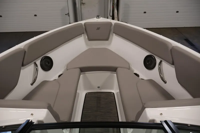 Slide: The Image of Interior of 2026 Four Winns H1 OB boat with cushioned seating and speakers. - 10