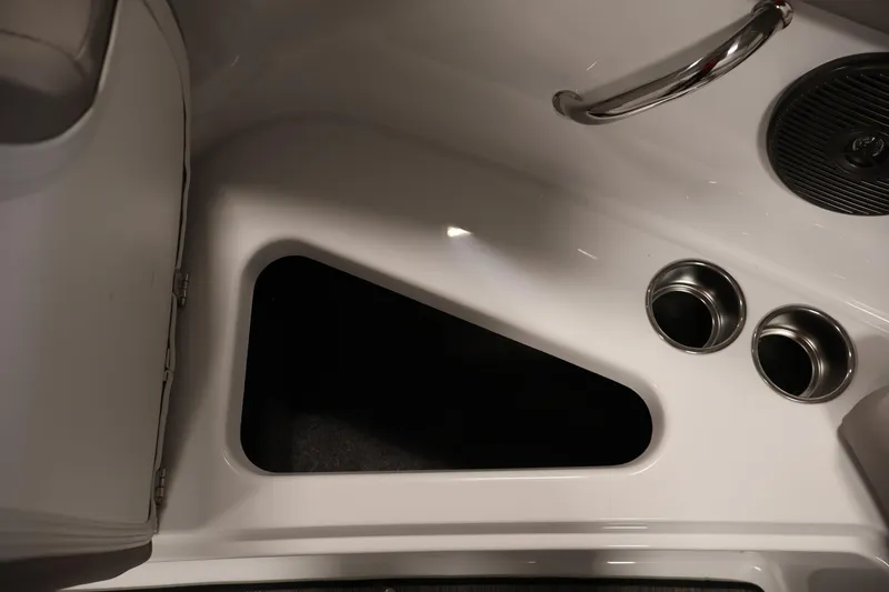 Slide: The Image of Interior detail of 2026 Four Winns H1 OB boat, featuring storage compartment and cup holders. - 13