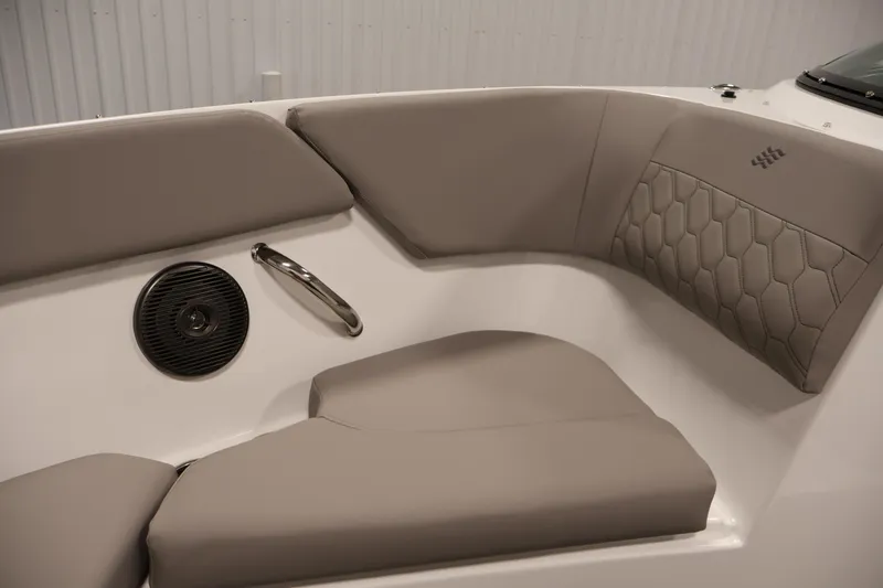 Slide: The Image of Interior seating of 2026 Four Winns H1 OB boat with beige upholstery and speaker. - 14