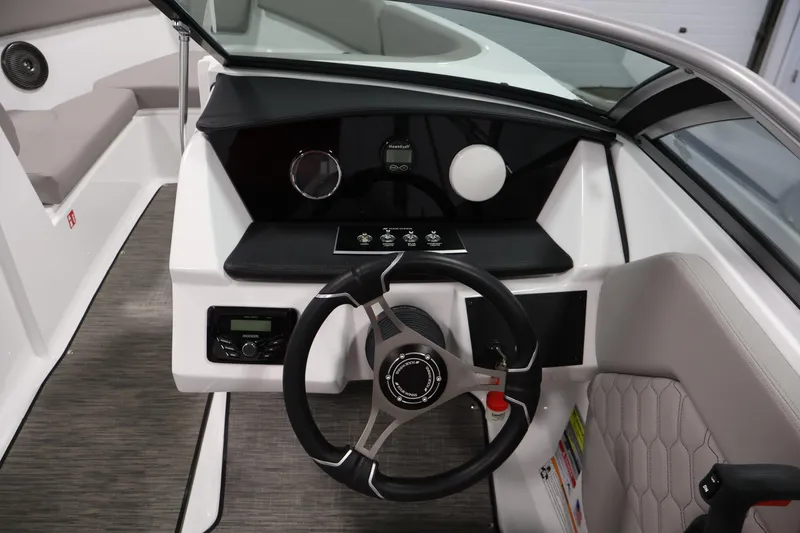 Slide: The Image of 2026 Four Winns H1 OB boat cockpit with modern steering wheel and dashboard controls. - 17