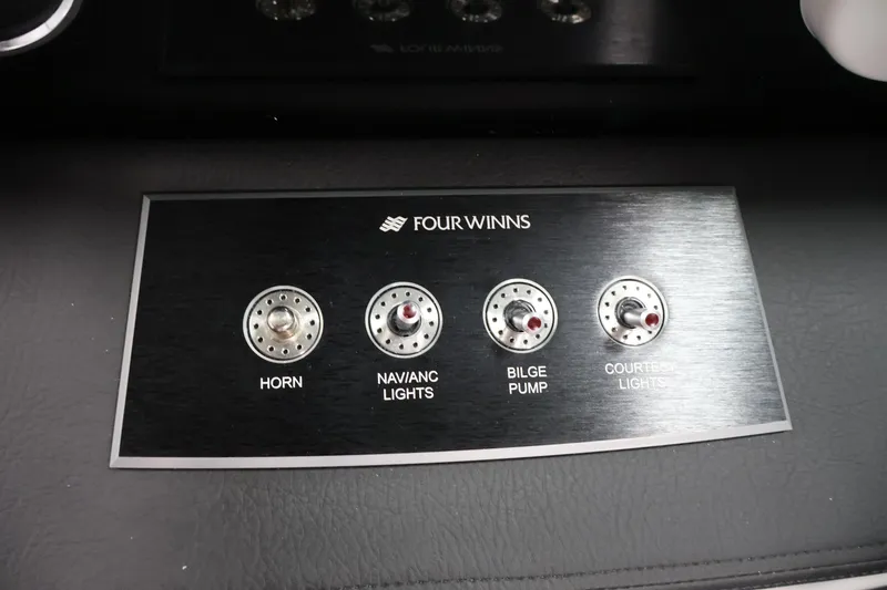 Slide: The Image of Control panel of 2026 Four Winns H1 OB boat with labeled switches. - 21