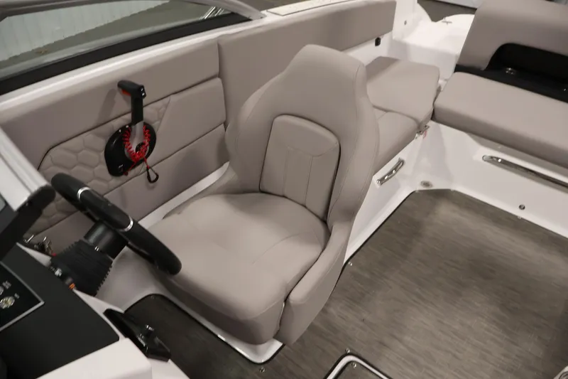 Slide: The Image of 2026 Four Winns H1 OB boat interior with gray seating and steering wheel. - 23