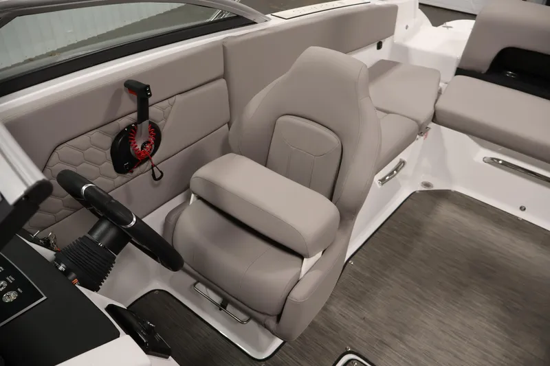 Slide: The Image of 2026 Four Winns H1 OB boat interior with gray seating and steering wheel. - 24