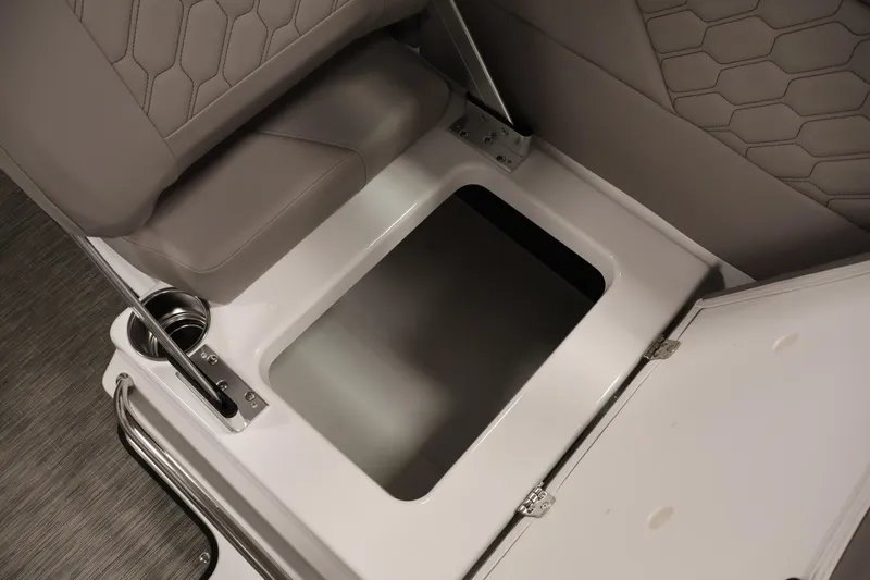 Slide: The Image of 2026 Four Winns H1 OB boat storage compartment with cushioned seating and cup holder. - 28