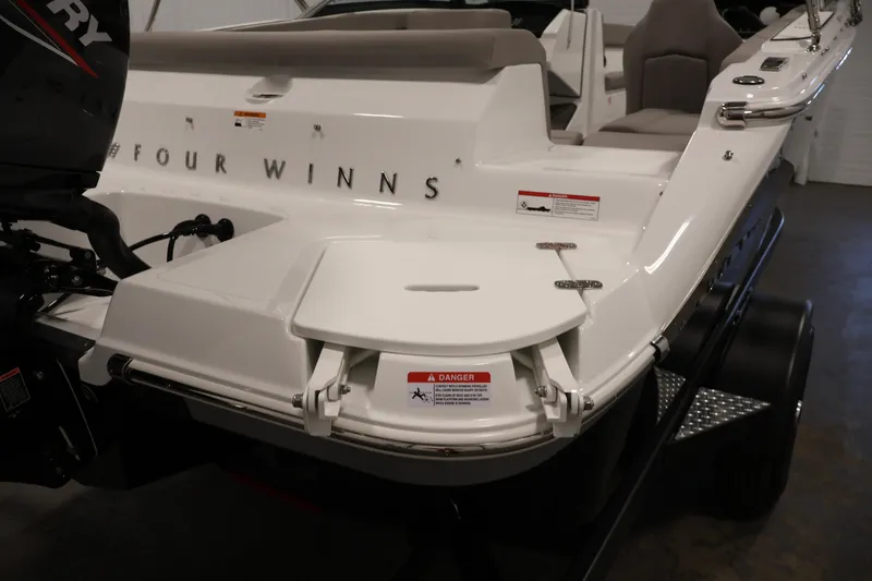 Slide: The Image of 2026 Four Winns H1 OB boat rear view with Mercury outboard motor. - 36