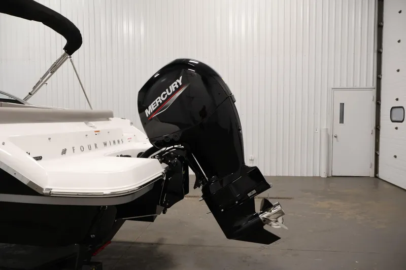 Slide: The Image of 2026 Four Winns H1 OB boat with Mercury outboard motor in a garage. - 37