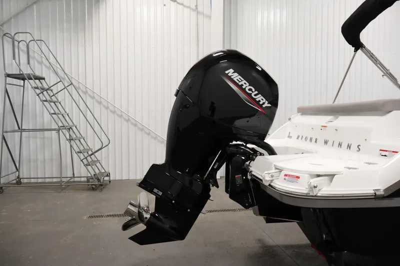 Slide: The Image of 2026 Four Winns H1 OB boat with Mercury outboard motor in a storage facility. - 38