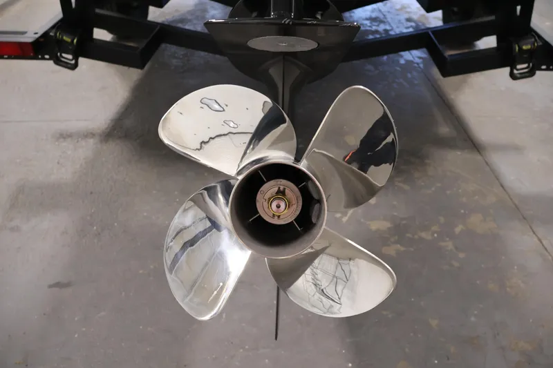 Slide: The Image of 2026 Four Winns H1 OB boat propeller, shiny metal blades, close-up view. - 39