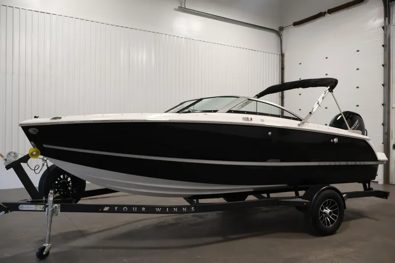 Slide: The Image of 2026 Four Winns H1 OB boat on trailer in indoor setting. - 7