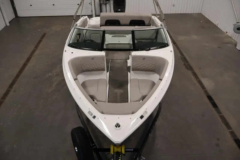 Slide: The Image of 2026 Four Winns H1 OB boat interior with spacious seating in a showroom. - 8