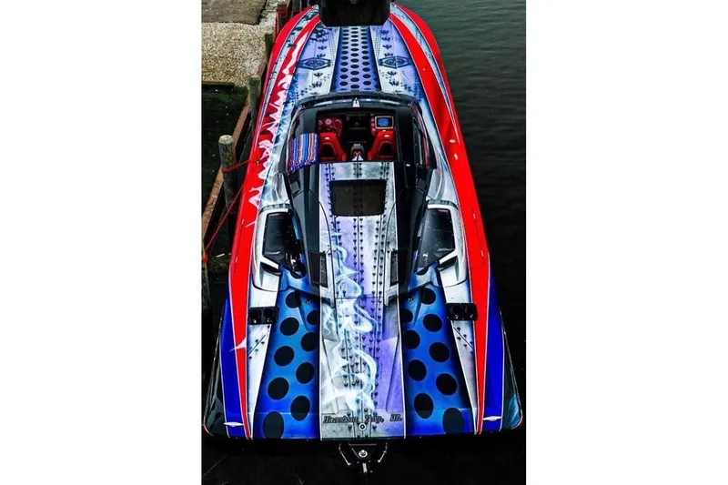 The Image of 2007 Nor-Tech 4700 Super Cat with vibrant, colorful design docked by the water. - 1