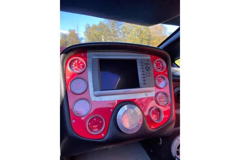 Slide: The Image of Dashboard of a 2007 Nor-Tech 4700 Super Cat with red gauges and Garmin display. - 15