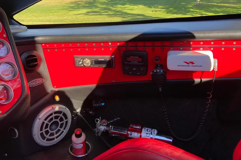 Slide: The Image of Interior of 2007 Nor-Tech 4700 Super Cat with red dashboard and marine electronics. - 16