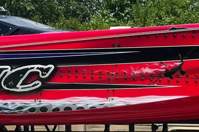 Slide: The Image of 2007 Nor-Tech 4700 Super Cat with vibrant red and black graphics. - 3