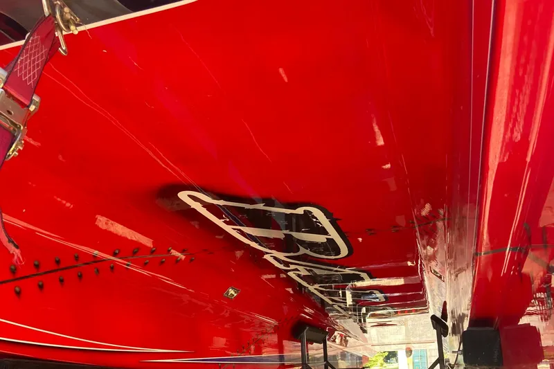 Slide: The Image of Red 2007 Nor-Tech 4700 Super Cat boat hull with bold graphics. - 6