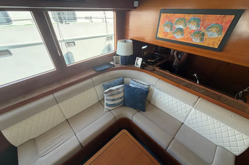 Slide: The Image of Luxurious 2016 Nordhavn 60 yacht interior with elegant seating and decorative pillows. - 10