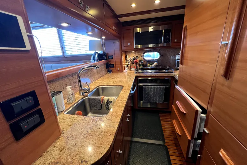 Slide: The Image of Luxurious 2016 Nordhavn 60 yacht kitchen with granite countertops and modern appliances. - 11