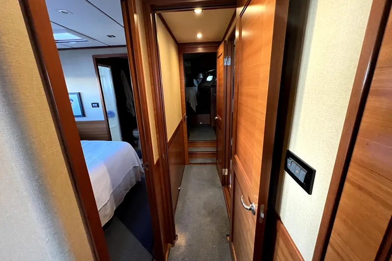 Slide: The Image of Hallway inside 2016 Nordhavn 60 yacht, featuring wooden doors and cozy interior design. - 13