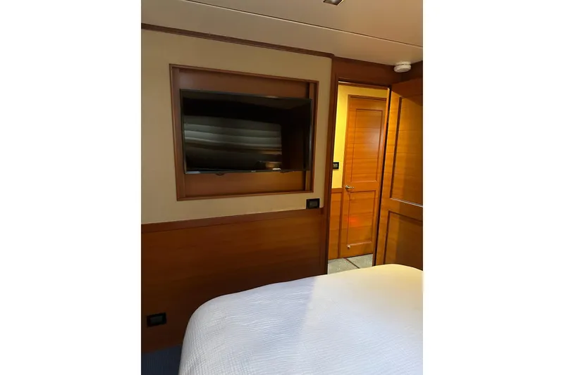 Slide: The Image of Bedroom interior of 2016 Nordhavn 60 yacht with TV and wooden door. - 15