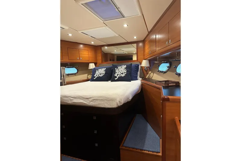 Slide: The Image of Luxurious 2016 Nordhavn 60 yacht bedroom with elegant wood finish and nautical decor. - 17