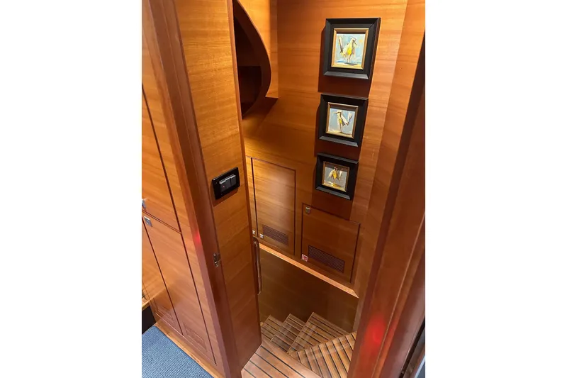 Slide: The Image of Wooden staircase with framed art in a 2016 Nordhavn 60 yacht interior. - 19