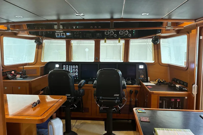 Slide: The Image of Pilothouse of 2016 Nordhavn 60 yacht with navigation equipment and dual captain chairs. - 20