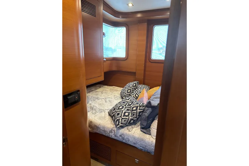 Slide: The Image of Cozy cabin interior of 2016 Nordhavn 60 yacht with bed and decorative pillows. - 21