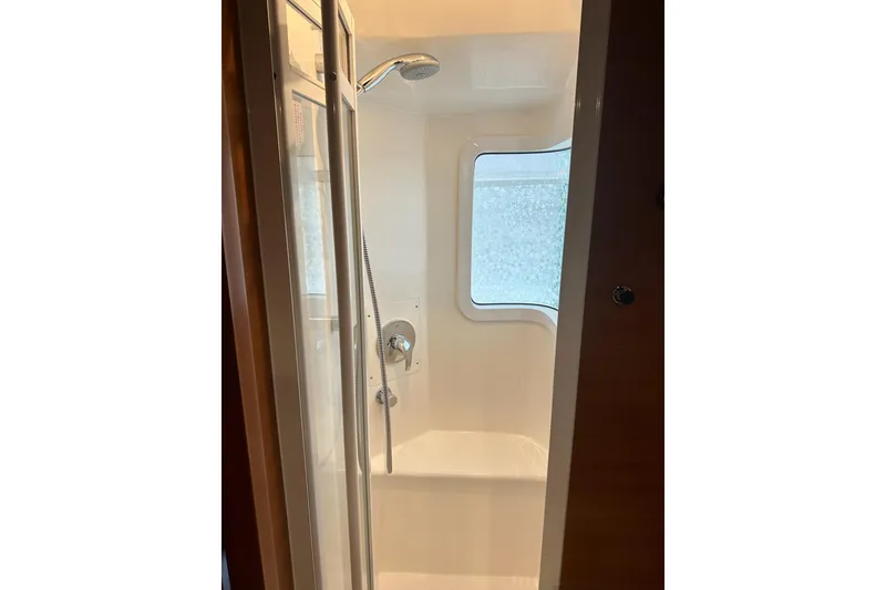 Slide: The Image of Shower area in 2016 Nordhavn 60 yacht with window and modern fixtures. - 23