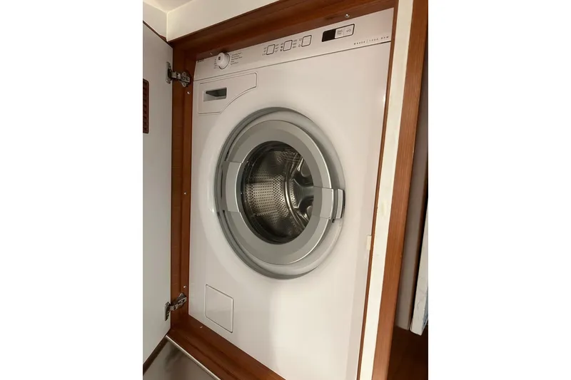 Slide: The Image of Washing machine inside a 2016 Nordhavn 60 yacht, wooden cabinet enclosure. - 25