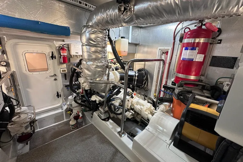 Slide: The Image of Engine room of 2016 Nordhavn 60 yacht, featuring machinery and safety equipment. - 28