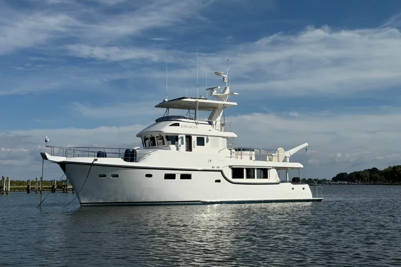 Slide: The Image of 2016 Nordhavn 60 yacht on calm water under a clear blue sky. - 3