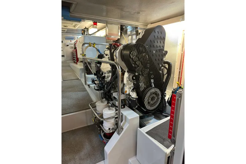 Slide: The Image of Engine room of a 2016 Nordhavn 60 yacht, showcasing mechanical components and systems. - 32