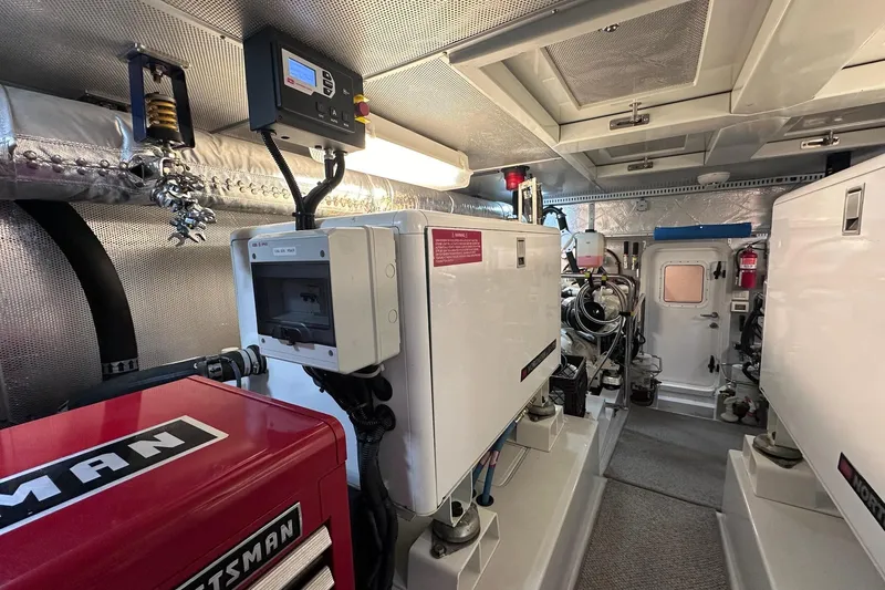 Slide: The Image of Engine room of a 2016 Nordhavn 60 yacht, featuring modern equipment and controls. - 34