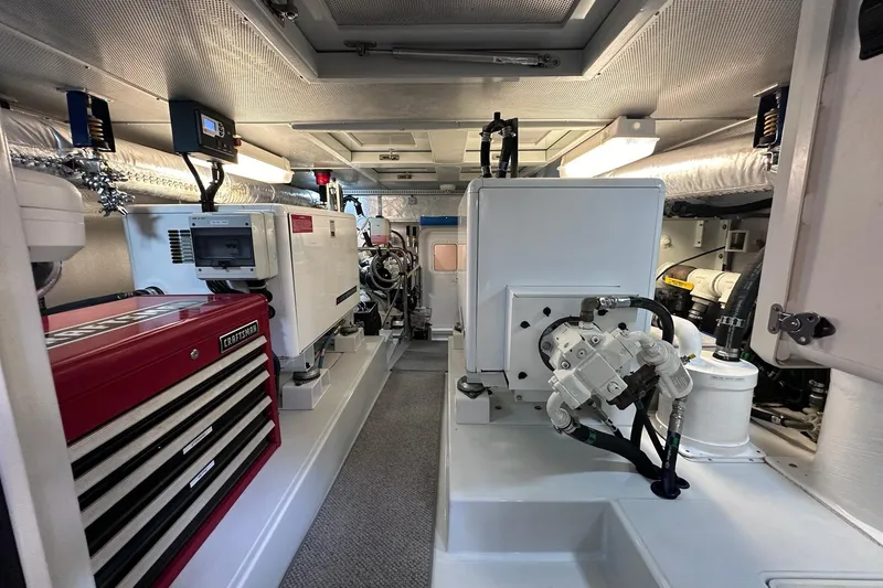 Slide: The Image of Engine room of a 2016 Nordhavn 60 yacht, featuring equipment and tool storage. - 35