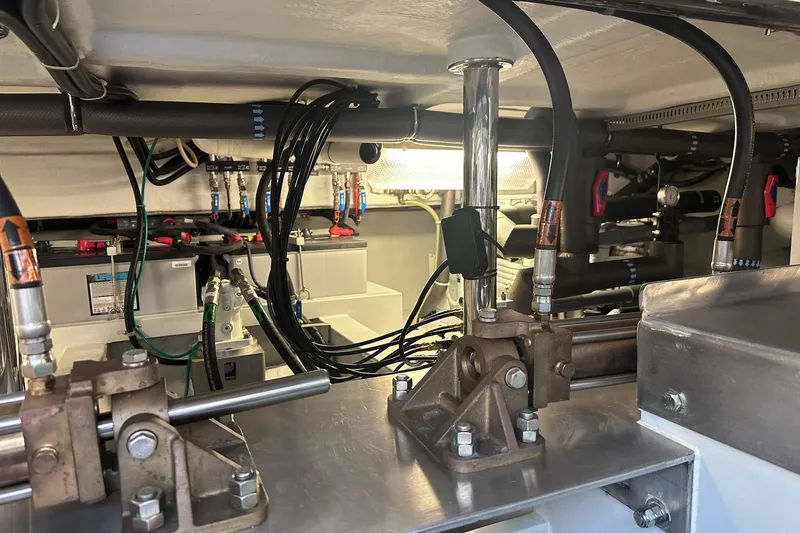 Slide: The Image of Engine room of a 2016 Nordhavn 60 yacht, showcasing mechanical components and wiring. - 39