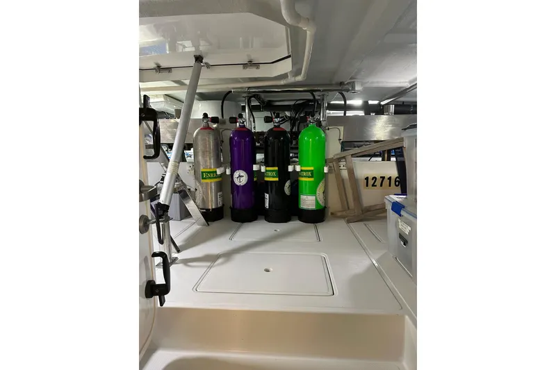 Slide: The Image of Diving equipment on 2016 Nordhavn 60 yacht, featuring colorful scuba tanks and gear storage. - 40