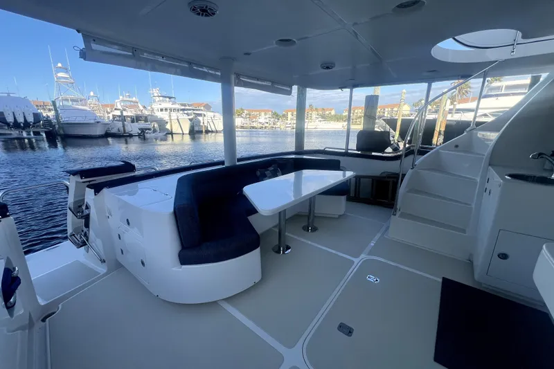 Slide: The Image of Luxurious 2016 Nordhavn 60 yacht interior with seating and table, docked at marina. - 6