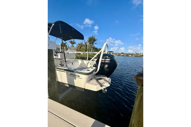 Slide: The Image of 2025 Boston Whaler 170 Montauk boat docked on a sunny day by the water. - 13