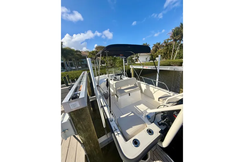 Slide: The Image of 2025 Boston Whaler 170 Montauk boat docked under clear blue sky. - 4