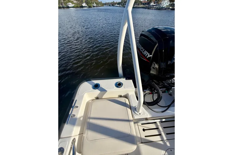 Slide: The Image of 2025 Boston Whaler 170 Montauk boat with Mercury engine on a calm waterway. - 6