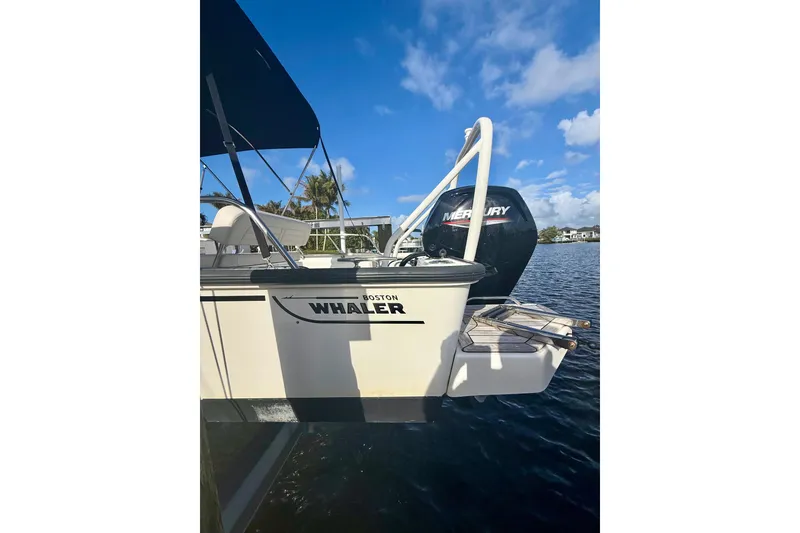 Slide: The Image of Boston Whaler 170 Montauk 2025 boat with Mercury engine on a sunny day. - 9