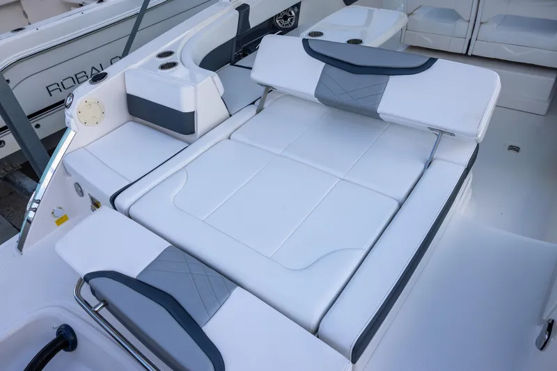 Slide: The Image of 2021 Chaparral 280 OSX boat interior with white cushioned seating and cup holders. - 10